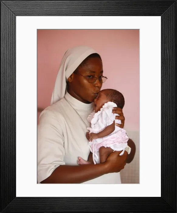 Framed Print : Franciscan sister holding an orphan at nursery and kindergarten run by Catholic nuns Framed Print : Franciscan sister holding an orphan at nursery and kindergarten run by Catholic nuns