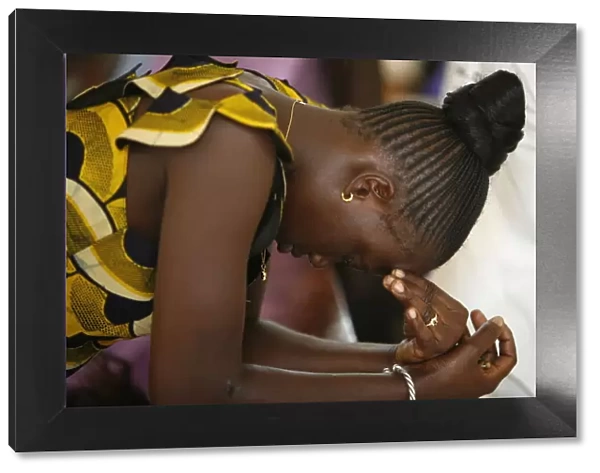 Woman praying at mass in Popenguine, Popenguine, Thies, Senegal, West Africa, Africa