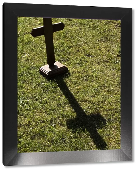 Shadow of a wooden cross on the lawn, St. Gervais-les-Bains, Haute-Savoie, France, Europe