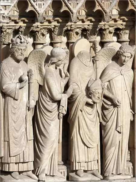 Detail of St. Denis holding his head flanked by two angels, Virgin portal, Western facade