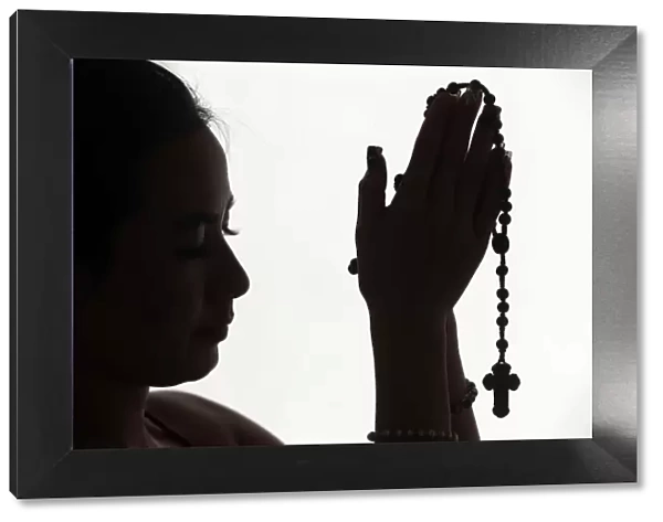 Christian woman praying the Rosary, Vietnam, Indochina, Asia