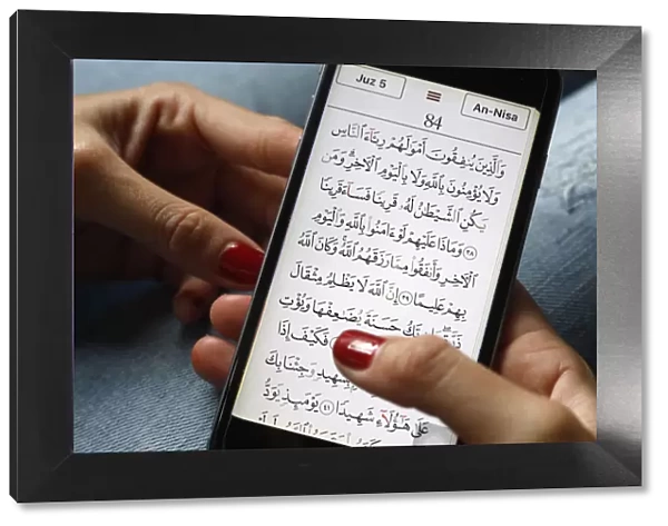 Young Muslim woman reading a digital Quran on a smartphone, Vietnam, Southeast Asia, Asia