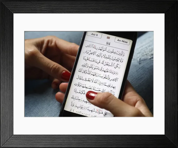 Framed Print : Young Muslim woman reading a digital Quran on a smartphone, Vietnam, Southeast Asia, Asia Framed Print : Young Muslim woman reading a digital Quran on a smartphone, Vietnam, Southeast Asia, Asia