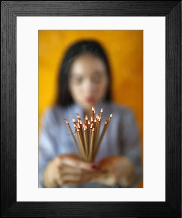 Framed Print : Woman praying with incense sticks in hands, Thien Hung Buddhist temple