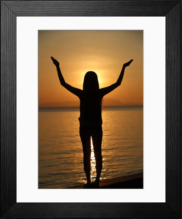 Framed Print : Silhouette of a woman standing by the sea at sunset doing yoga pose and meditation, Kep Framed Print : Silhouette of a woman standing by the sea at sunset doing yoga pose and meditation, Kep