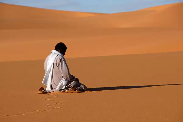 Muslim man praying in the desert, Sebha, Ubari, Libya, North Africa, Africa