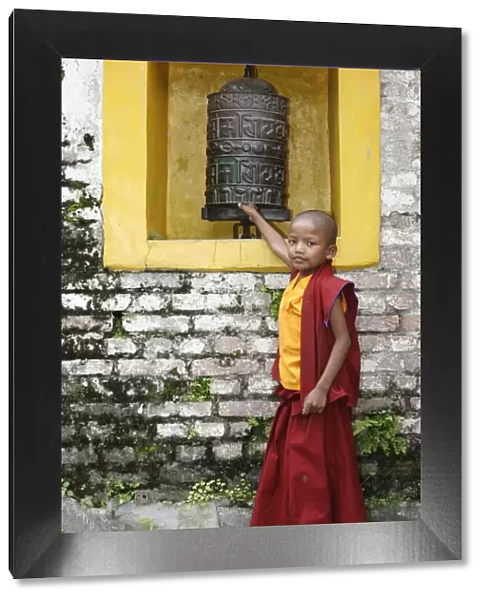 Young monk and prayer wheel, Swayambhunath temple, Kathmandu, Nepal, Asia