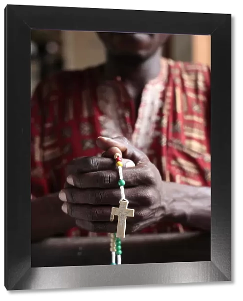 African man praying the rosary, Cotonou, Benin, West Africa, Africa