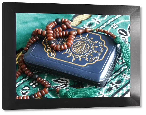Quran and Islamic prayer beads on a prayer mat, Paris, France, Europe