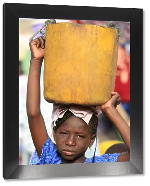 Girl carrying a heavy load, St. Louis, Senegal, West Africa, Africa