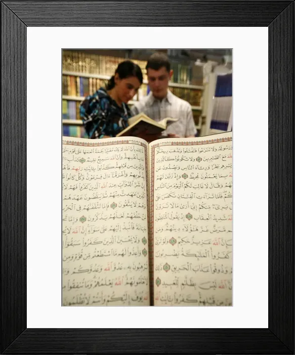 Framed Print : Couple reading the Koran at U. O. I. F. annual meeting, Paris, France, Europe Framed Print : Couple reading the Koran at U. O. I. F. annual meeting, Paris, France, Europe