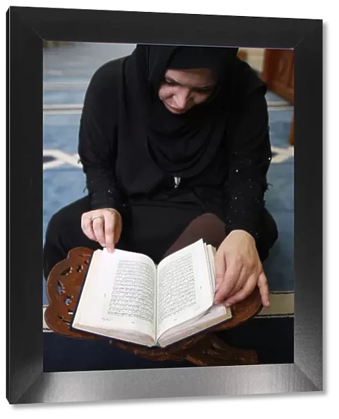 Woman reading Koran in Jumeirah mosque, Dubai, United Arab Emirates, Middle East