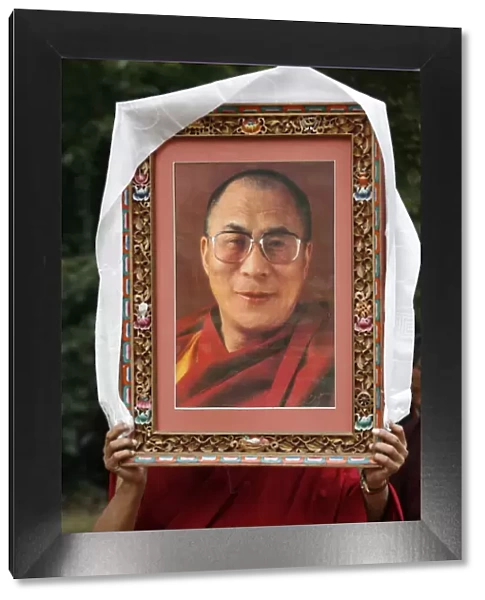 Buddhist holding a picture of the Dalai Lama, Paris, Ile de France, France, Europe