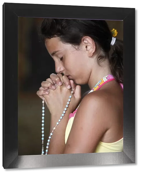 Girl praying with rosary beads, Alezio, Lecce, Italy, Europe