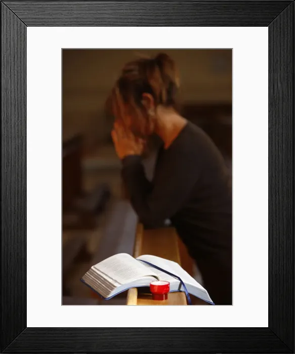 Framed Print : Candle and Bible, with woman praying in the background, Saint Nicolas de Veroce Framed Print : Candle and Bible, with woman praying in the background, Saint Nicolas de Veroce