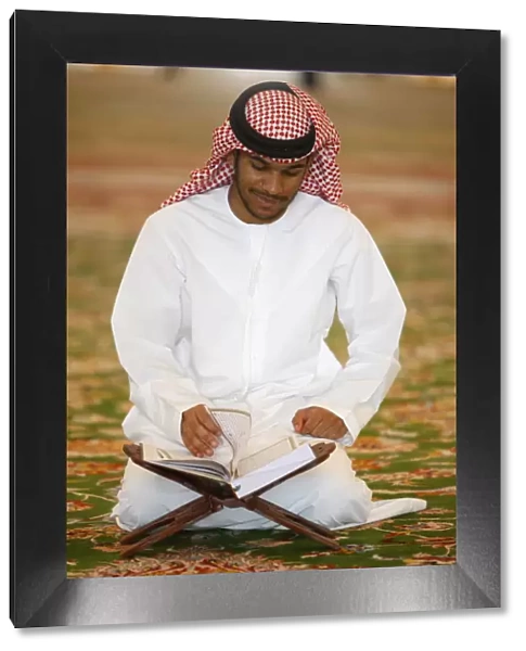 Muslim man reading the Koran, Sheikh Zayed Grand Mosque, Abu Dhabi, United Arab Emirates