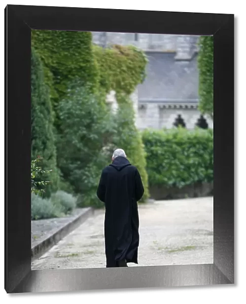 Monk walking in Saint-Pierre de Solesmes Abbey, Solesmes, Sarthe, Pays de la Loire