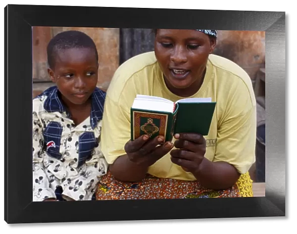 African mother reading the Koran, Lome, Togo, West Africa, Africa