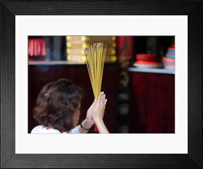 Framed Print : Worshipper burning incense sticks, Taoist temple, Phuoc An Hoi Quan Pagoda
