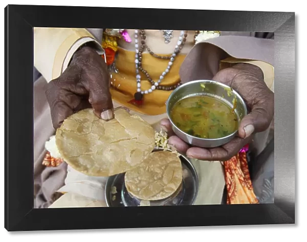 Sadhu eating vegetarian food, Dauji, Uttar Pradesh, India, Asia