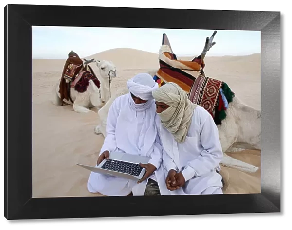 Bedouins using a laptop in the Sahara, Douz, Kebili, Tunisia, North Africa, Africa