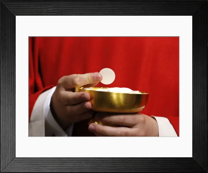 Framed Print : Catholic priest giving Holy Communion, Paris, France, Europe Framed Print : Catholic priest giving Holy Communion, Paris, France, Europe