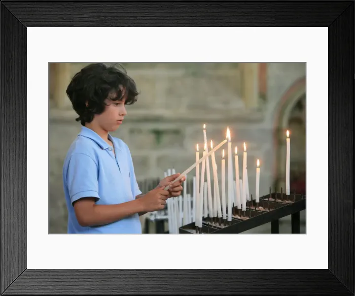 Framed Print : Boy lighting a church candle Framed Print : Boy lighting a church candle