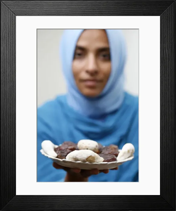 Framed Print : Muslim woman offering Ramadan pastries Framed Print : Muslim woman offering Ramadan pastries