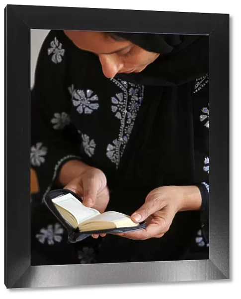 Veiled woman reading Koran, Montrouge, Hauts de Seine, France, Europe