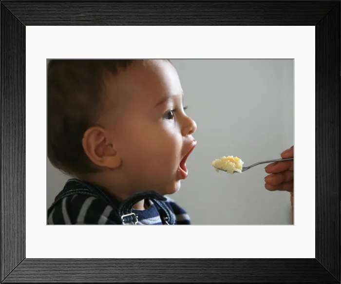 Framed Print : Baby feeding, France, Europe Framed Print : Baby feeding, France, Europe