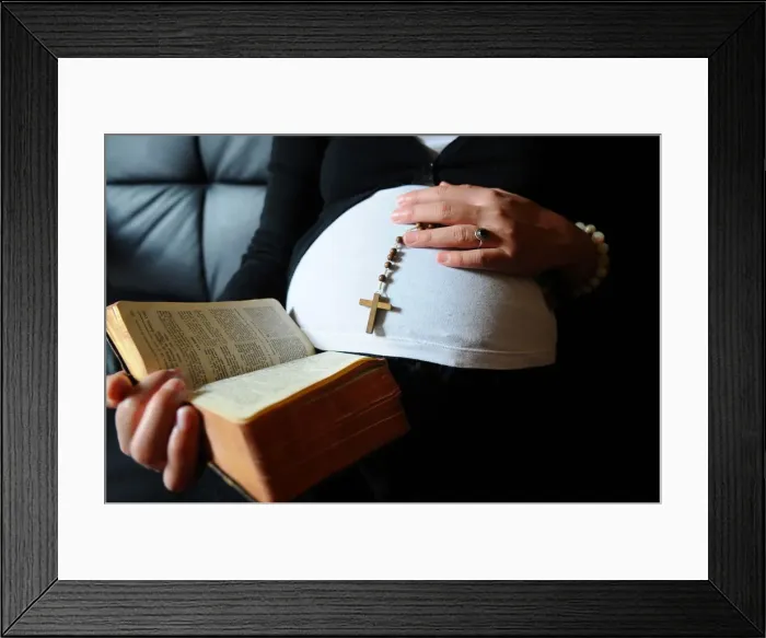Framed Print : Christian pregnant woman reading the Bible, Paris, France, Europe Framed Print : Christian pregnant woman reading the Bible, Paris, France, Europe