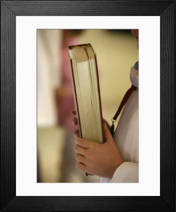 Framed Print : Altar boy carrying book, France, Europe