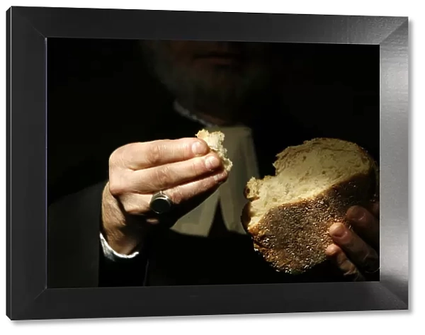 Protestant minister holding Communion bread, Geneva, Switzerland, Europe