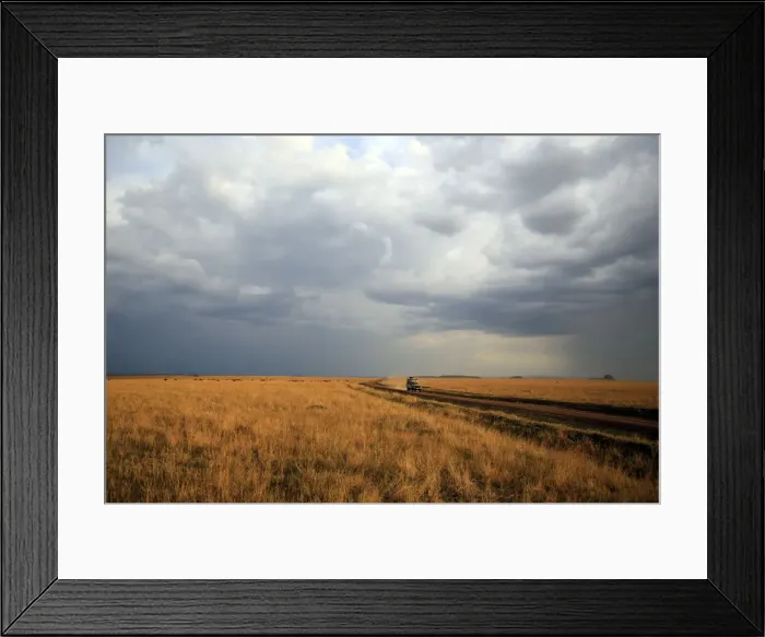 Framed Print : An off-road vehicle driving in the African savanna, Masai Mara Game Reserve, Kenya Framed Print : An off-road vehicle driving in the African savanna, Masai Mara Game Reserve, Kenya