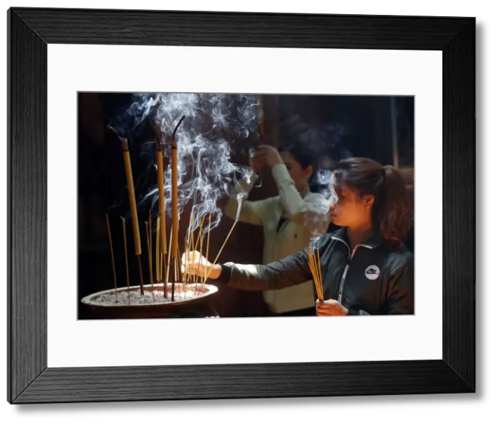 Framed Print : Taoist temple, Emperor Jade pagoda (Chua Phuoc Hai), Buddhist worshipper burning incense Framed Print : Taoist temple, Emperor Jade pagoda (Chua Phuoc Hai), Buddhist worshipper burning incense