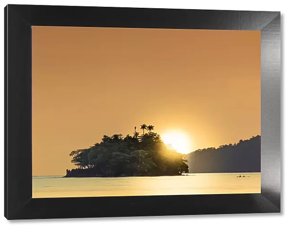 The sun setting behind islets in the Banda archipelago, Banda, Maluku, Spice Islands