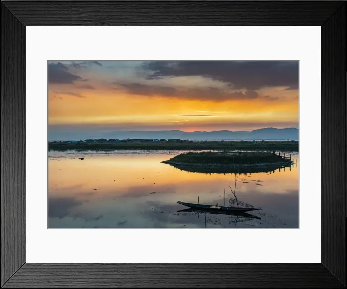 Framed Print : Clouds and traditional rowing boat reflecting in the water at sunset, Inle Lake