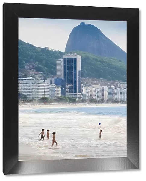 Locals playing ball in the surf, Copacabana Beach, Rio de Janeiro, Brazil, South America