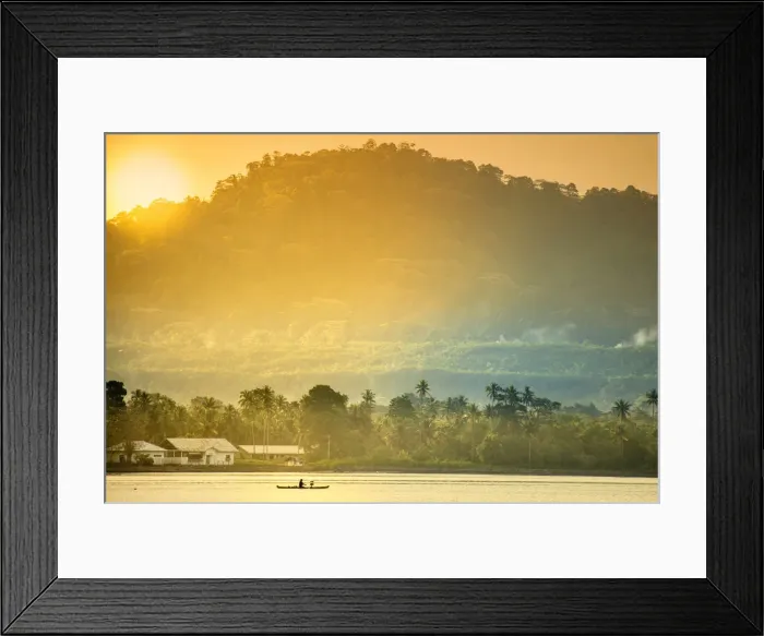 Framed Print : A local fisherman in a traditional canoe in front of the ridges of the Banda islands Framed Print : A local fisherman in a traditional canoe in front of the ridges of the Banda islands