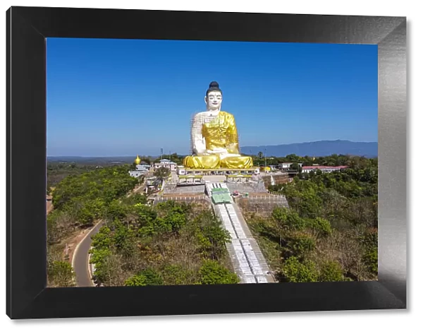 Aerial of a giant sitting Buddha below the Kyaiktiyo Pagoda (Golden Rock), Mon state