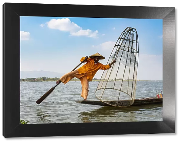 Fisherman at Inle Lake with traditional Intha conical net, fishing net, leg rowing style