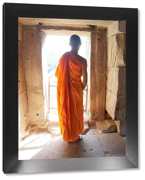 A Buddhist monk exploring the Angkor Archaeological Complex, UNESCO World Heritage Site