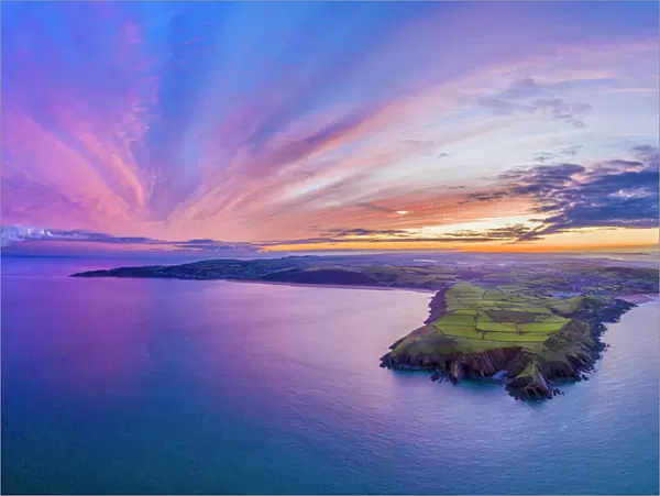 Aerial sunrise view over Baggy Point towards Woolacombe, Morte Bay, North Devon, England