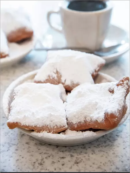 Famous food of New Orleans, beignets and chicory coffee at Cafe Du Monde, New Orleans
