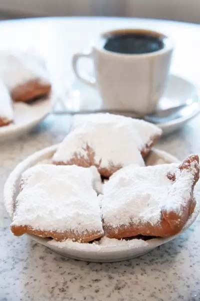 Famous food of New Orleans, beignets and chicory coffee at Cafe Du Monde, New Orleans