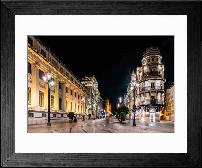 Framed Print : The lights of Sevilles buildings at night looking down the Avenida de la
