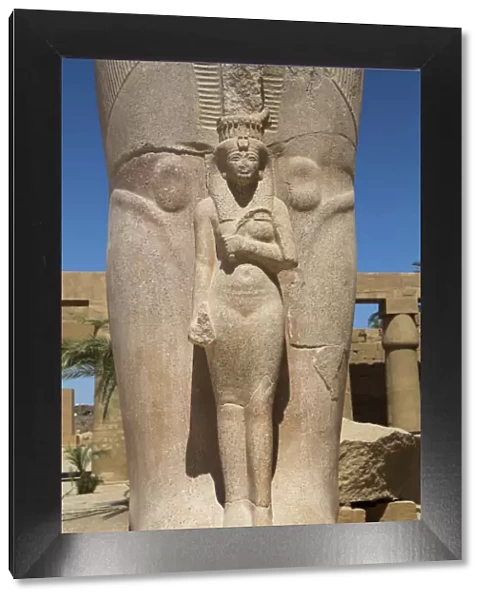 Statue of Nefetari, at base of statue of Ramses II, Great Court, Karnak Temple Complex