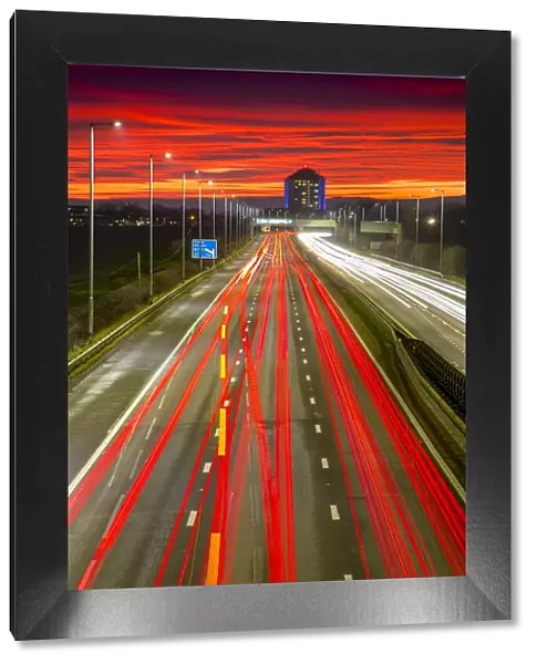 Red sky sunset, traffic light trails, M8 Motorway, Scotland, United Kingdom, Europe