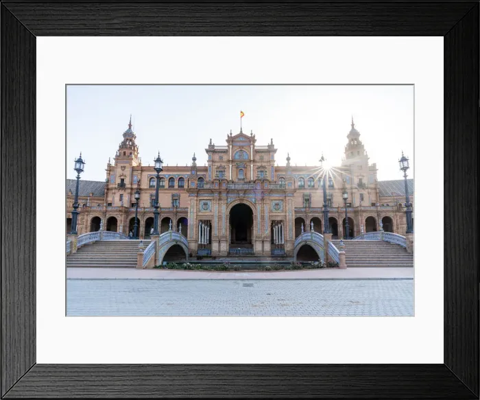 Framed Print : A sun burst as it rises over the central building of Plaza de Espana Framed Print : A sun burst as it rises over the central building of Plaza de Espana