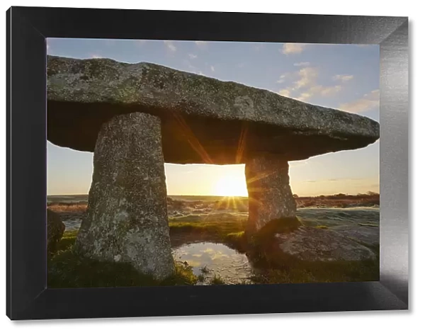 A sunrise view of the remains of a prehistoric burial chamber, known as Lanyon Quoit